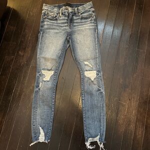 Buckle Distressed Skinny Jeans in Blue